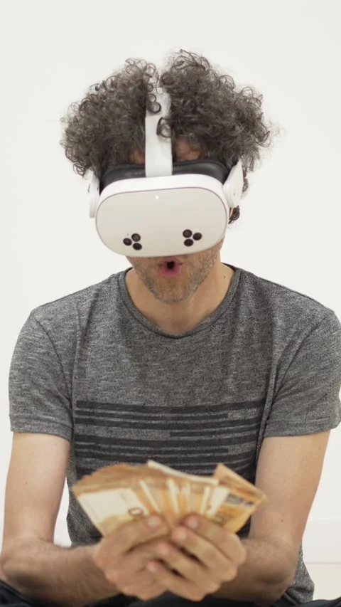 Man counting money in virtual reality headset Stock Footage 309772182