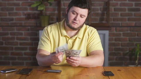 Man counting one hundred dollars bills. Businessman count money cash banknotes. 库存影片 142991254