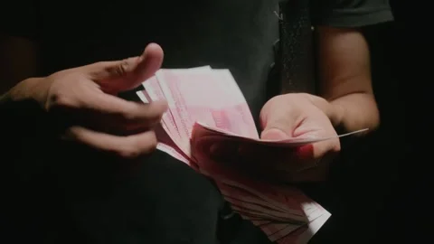 Man Counting Pink Banknotes in Dark Room, Close-up Shot 库存影片 334639021