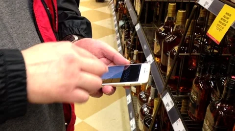 Man counting price of wine inside BC liquor store. Stock Footage 55493405