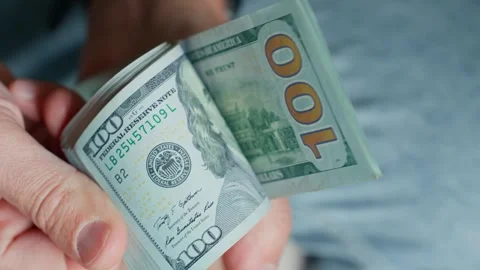 Man counting stack of dollar bills Stock Footage 290298078