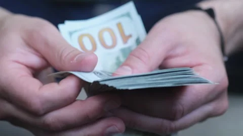 Man counting a stack of hundred dollar banknotes 10.09.2023 - Minsk, Belarus Stock-Footage 255374169