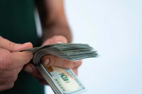 Man counting stack of hundred dollar bills Stock Photos