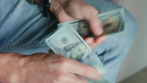 Man counting stack of one hundred dollar bills Stock Footage 288800806