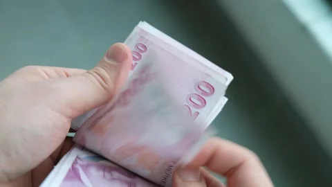 The man is counting Turkish banknotes in his hand. Stock Footage 256587457