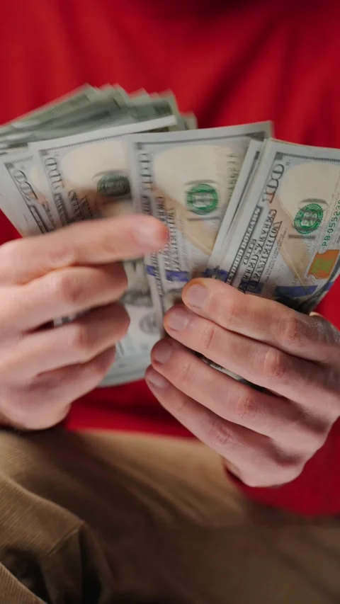 Man counting US Dollar bills, close-up. Vertical video Stock Footage 301542459