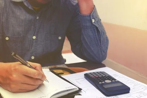 Man counting using calculator and stress in problem with expenses. Stock Photos