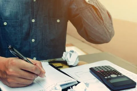 Man counting using calculator and stress in problem with expenses. Stock Photos