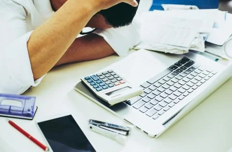 Man counting using calculator and stress in problem with expenses. Stock Photos