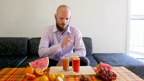 Man counting vitamins and thinking Stock Footage 112037988