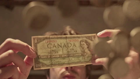 Man counts coins at a low angle perspective while seated at a table Stock Footage 319965784