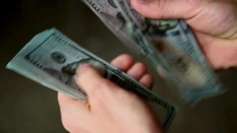 A man counts dollar bills for his investments. Closeup of hands counting do.. Stock Footage 266471502