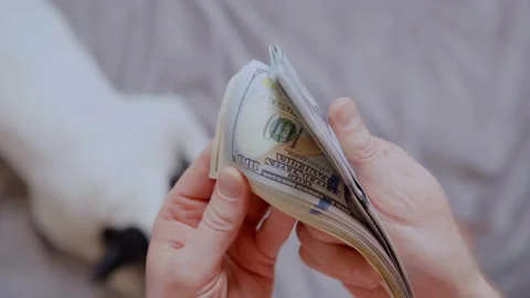 A man counts dollar bills for his investments. Closeup of hands counting do.. Stock Footage 266471789