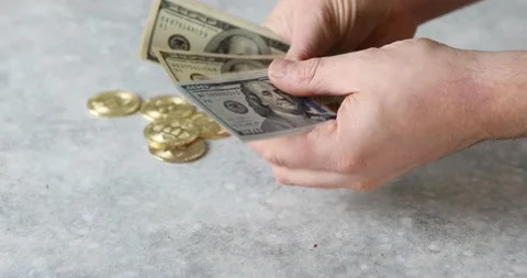 Man counts dollars. Bitcoin cryptocurrency and US dollars cash Stock Footage 165919812