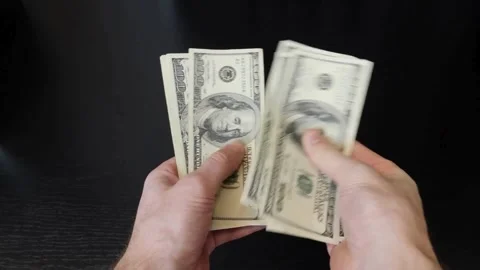 A man counts dollars. Budget, loan payment, investment planning, calculatin.. Stock Footage 266473072
