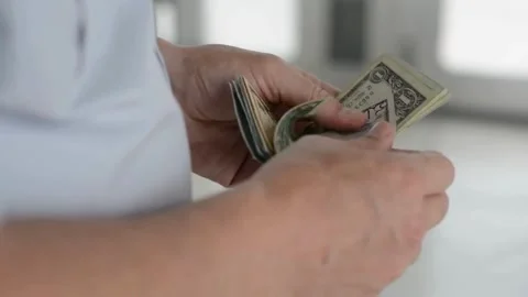 A man counts dollars. Budget, loan payment, investment planning, calculating Stock-Footage 336262413
