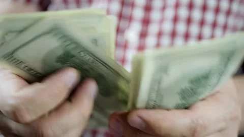 A man counts dollars. Budget, loan payment, investment planning, calculating Stock-Footage 336262595
