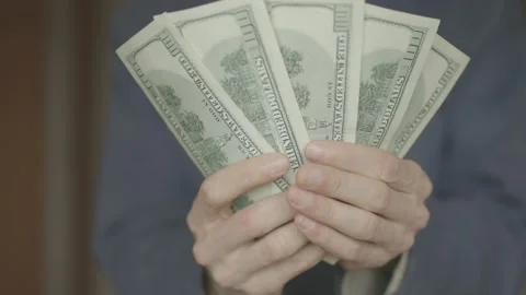 Man counts dollars in his hands. close-up shot. Stock Footage 133123398