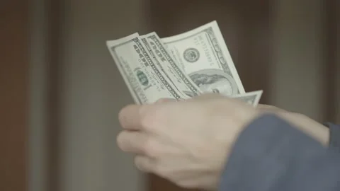 Man counts dollars in his hands. close-up shot. Stock Footage 133123422