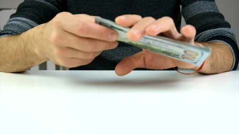 A man counts dollars in his hands. Selective focus. Stock Footage 223104409