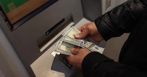Man counts dollars withdrawn from ATM. 24-hour service Stock Footage 252813396