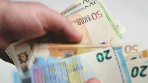 The man counts euros on the white table, calculates salary Stock Footage 148401382
