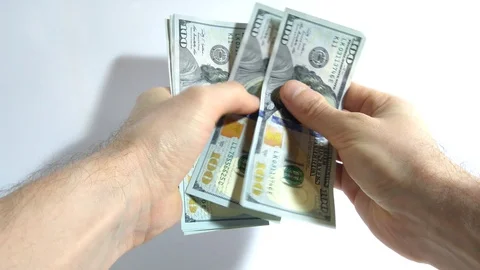 A man counts hundred dollar bills on a light background Stock-Footage 127758846