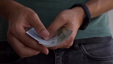 A man counts money from different countries, slow motin. Hands of a man count Stock Footage 115850899