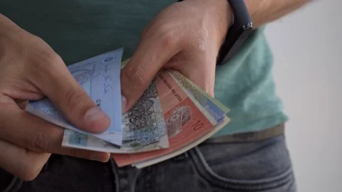 A man counts money from different countries. Hands of a man close-up count money Stock Footage 115851340
