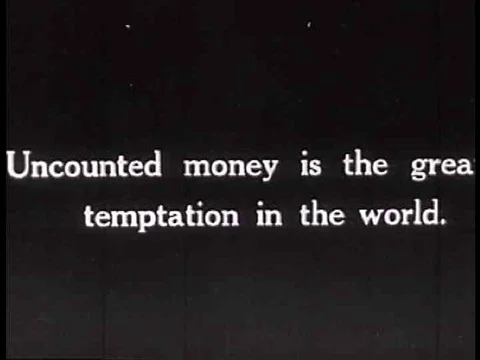 A man counts money in a general store in this silent film from the 1920's while Stock Footage 74777256