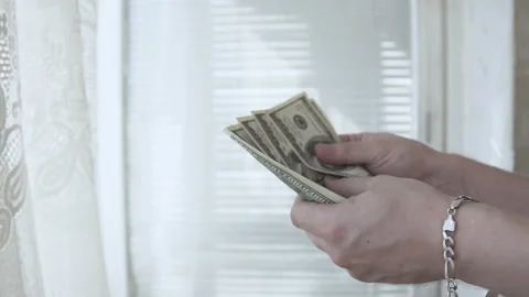  Man counts money in the hands of dollars close-up Stock Footage 135806736
