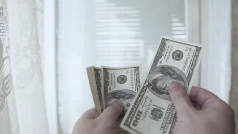  Man counts money in the hands of dollars close-up Stock Footage 135806744