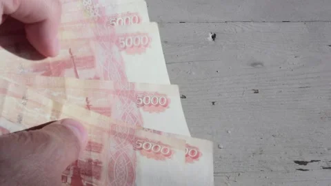 Man counts red paper 5000 rubles bills. Russian cash money in male hand Video stock 276569768