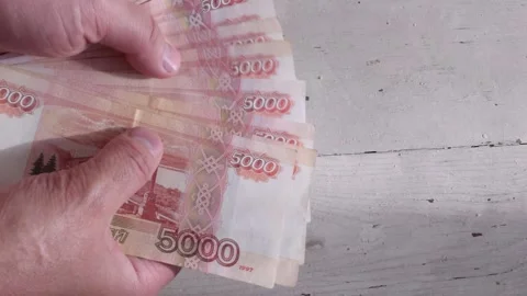Man counts red paper bills. 5000 rubles. Stock Footage 235557807