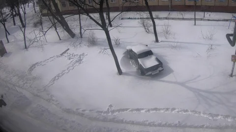 A man counts snow from a car Stock Footage 87452621