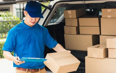 Man courier in uniform hold documents clipboard checking list parcel post box Stock Photos