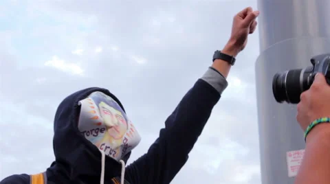 Man cover his face with a drawing of one student disappeared in Ayotzinapa. Stock Footage 44271773