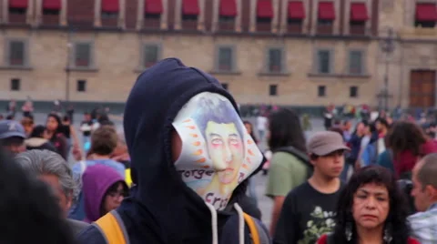 Man cover his face with a drawing of one student disappeared in Ayotzinapa. Stock Footage 44279307