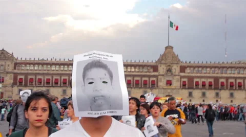 Man cover his face with a drawing of one student disappeared in Ayotzinapa. Stock Footage 44350842