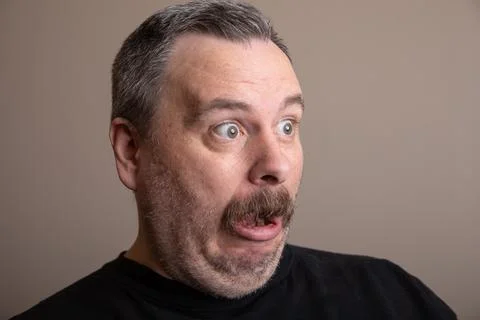 Man covered in snow, stunned expression Stock Photos