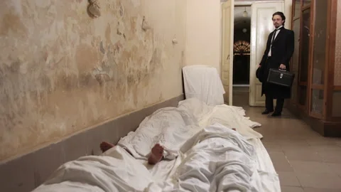 Man covered white sheet after murder of russian occupier, lot of corpses. Group Stock-Footage 197002372