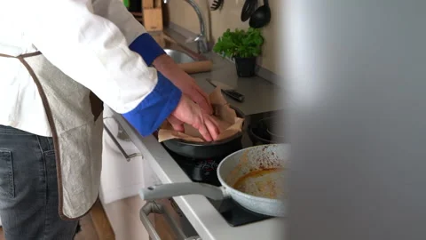 Man covering baking pan with baking paper Stock Footage 161158931