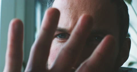 Man covering camera view with his fingers Stock Footage 203579482