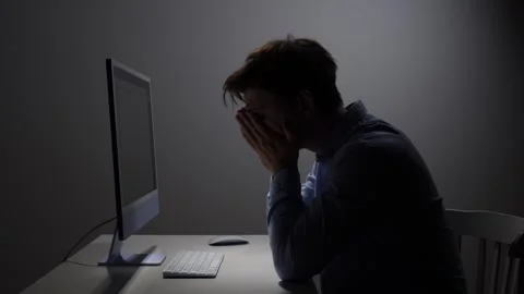Man covering his face with hands, showing extreme fatigue and frustration while Stock Footage 342672775