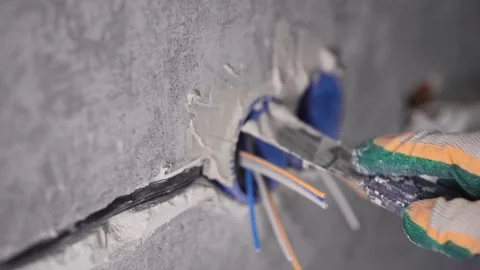 The man is covering a hole in the wall Stockbeeldmateriaal 147077426