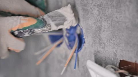 The man is covering a hole in the wall Stockbeeldmateriaal 147077428