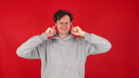 Man covers ears with fingers, does not want to listen to screams, loud music Видео 304749166