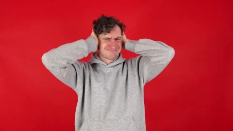 Man covers ears with palms, does not want to listen to screams Stock Footage 304750447