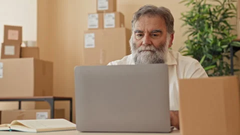 Man covers face with hands at cluttered desk with laptop, open notebook and.. Stock Footage 339203086