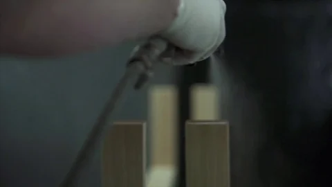 A man covers a tree with paint, paints a part with a spray. A factory worker  Stock Footage 84043297